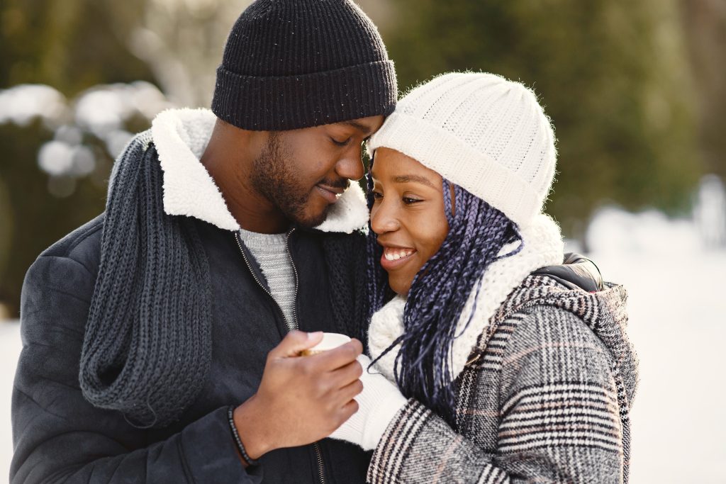 african american couple in a winter forest